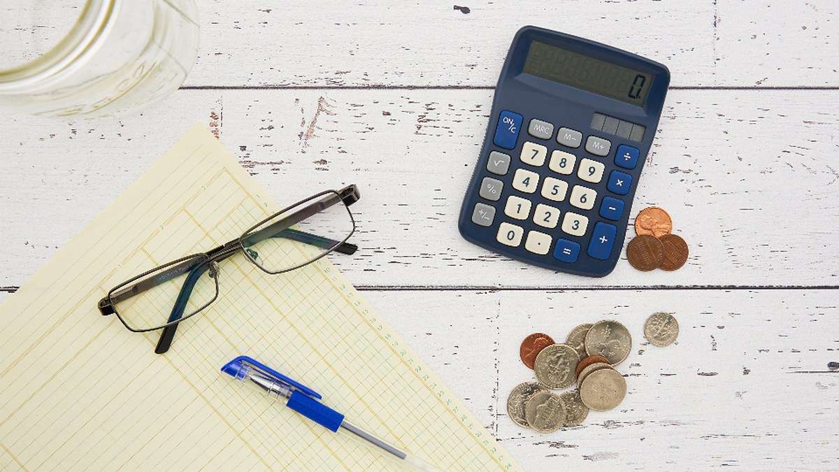 מחשבון, משקפיים ומסמכים על שולחן לצורך השוואת הצעות ריבית משכנתא בין בנקים